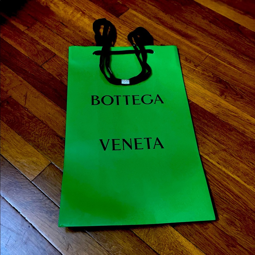 Some wear on bag from taking purchase home. Black handles silver decoration.